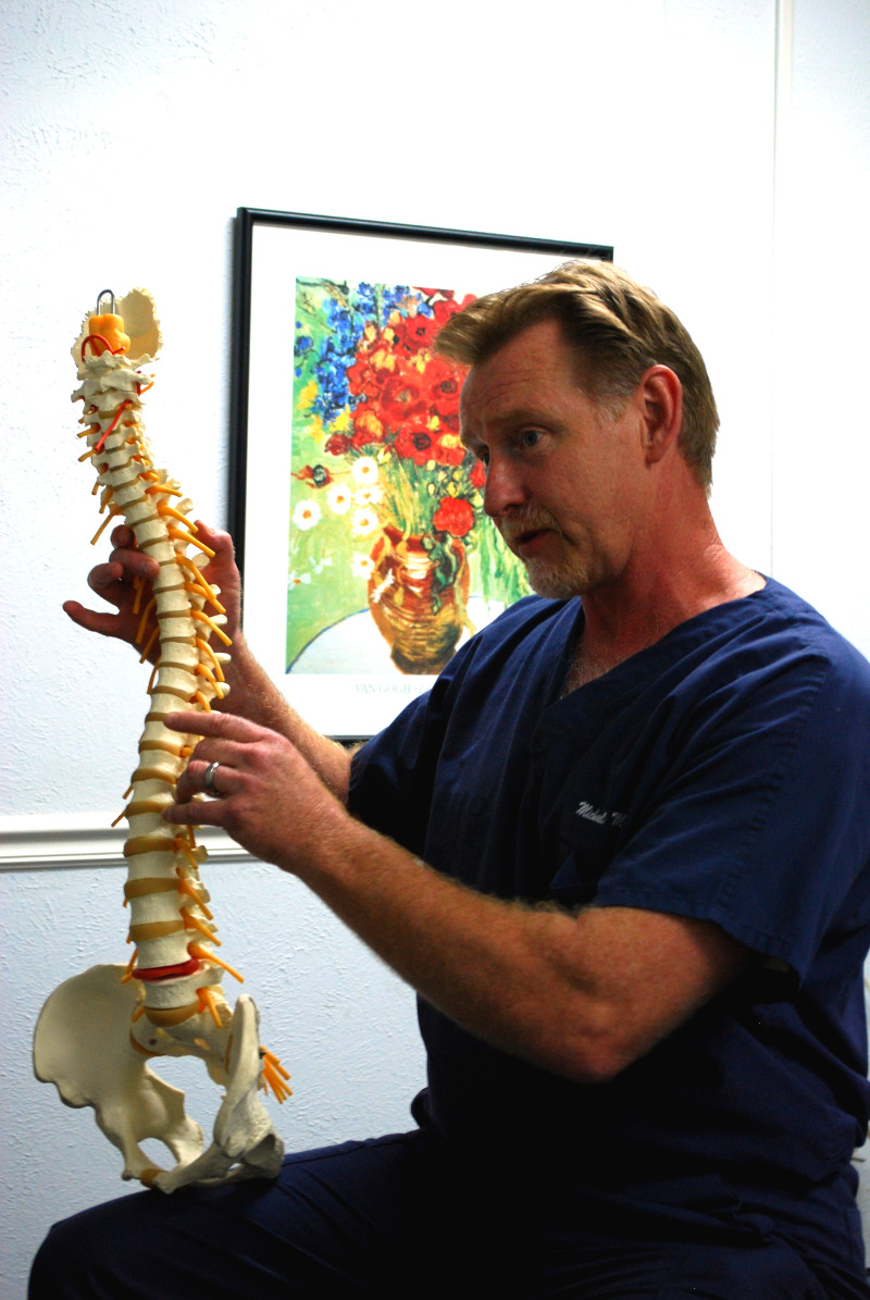 Dr. Martin holding up a model of a spine